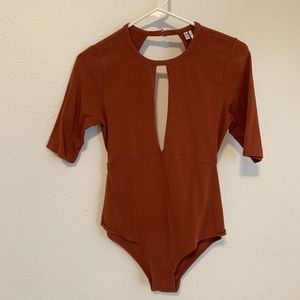 Body suit with open front and low cut back